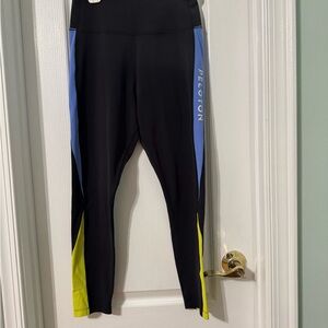 Peloton Women’s Black Leggings with Blue Panels and Yellow Accents